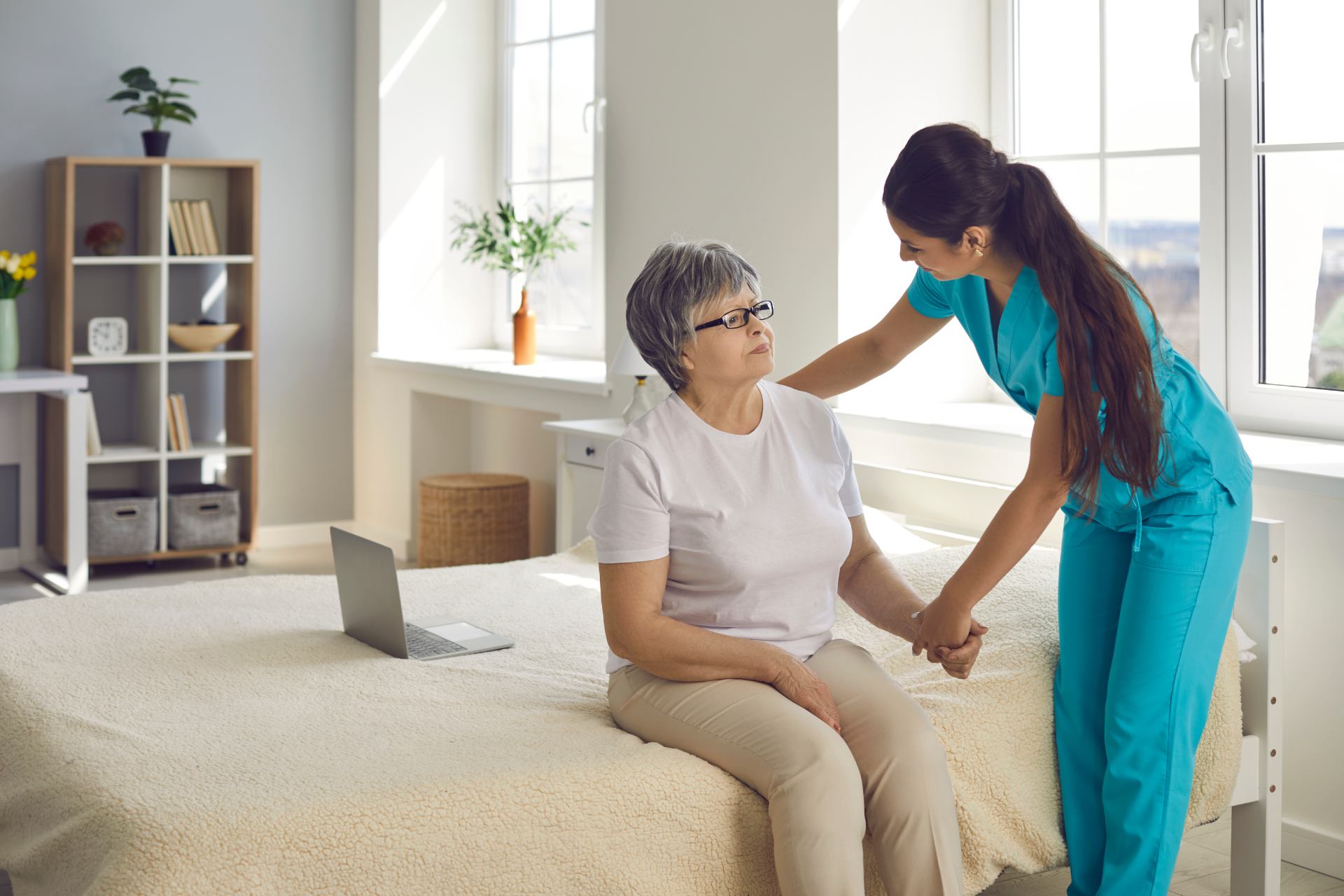 Nurse assisting elderly woman indoors