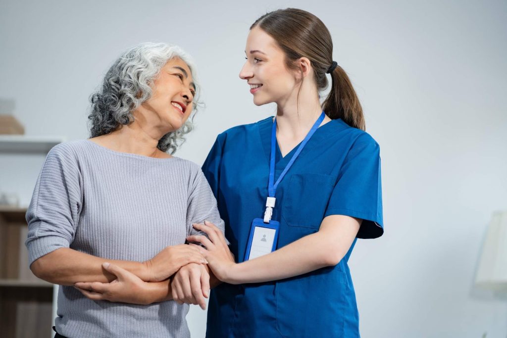 Nurse and patient smiling together