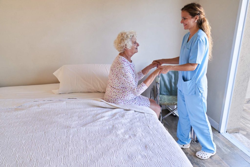 Caregiver assisting elderly woman