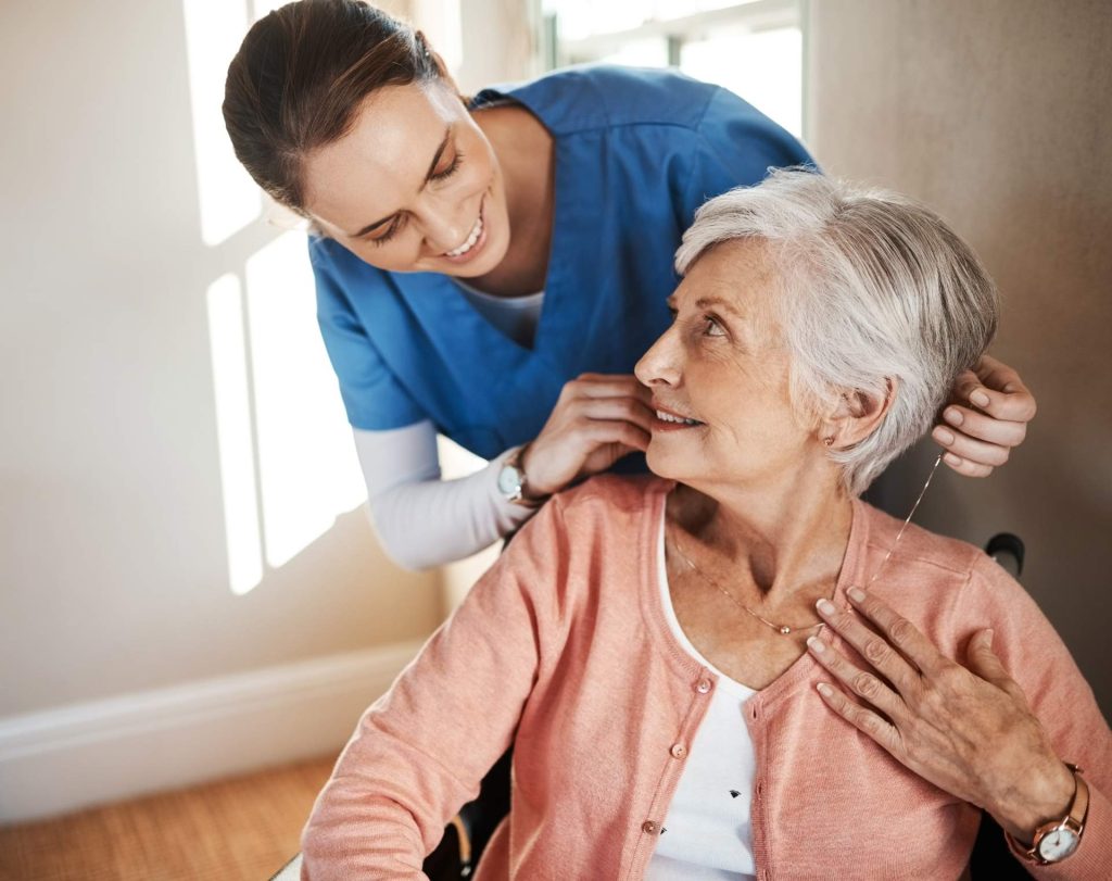 Caregiver assisting elderly woman