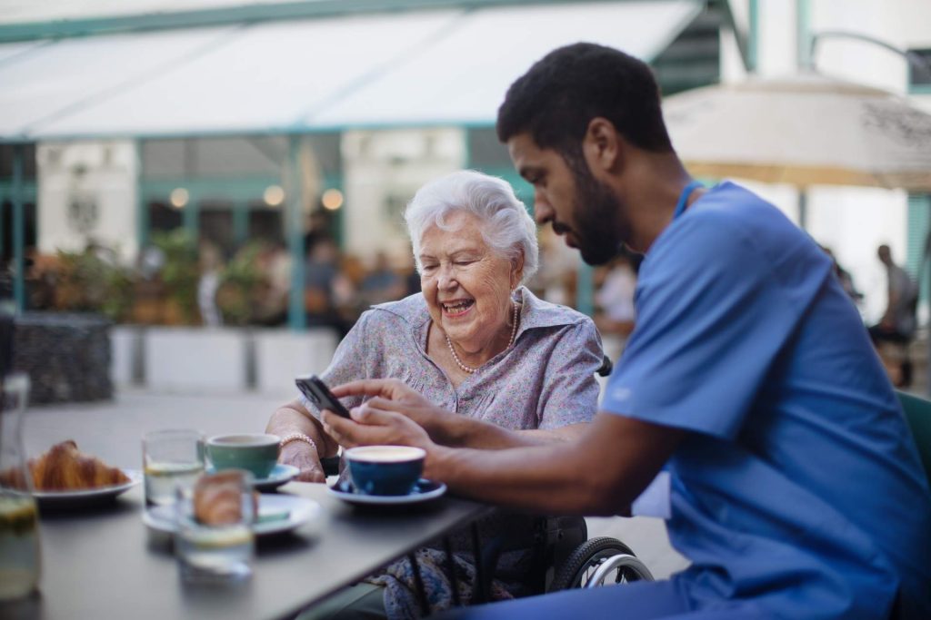 Elderly woman smiling with caregiver