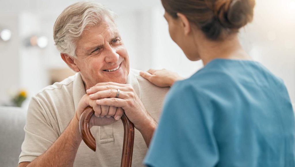 Elderly man interacting with caregiver